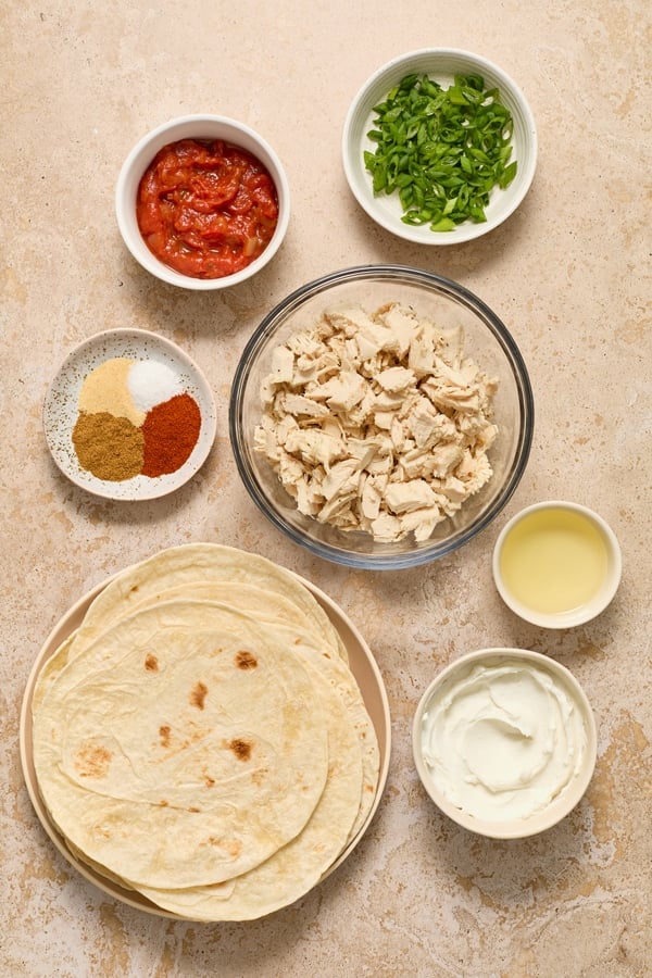 Ingredients for chicken taquitos in small bowls.