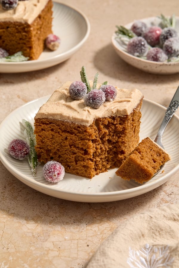 A piece of Dairy Free Gingerbread Cake with a bite taken with a fork.